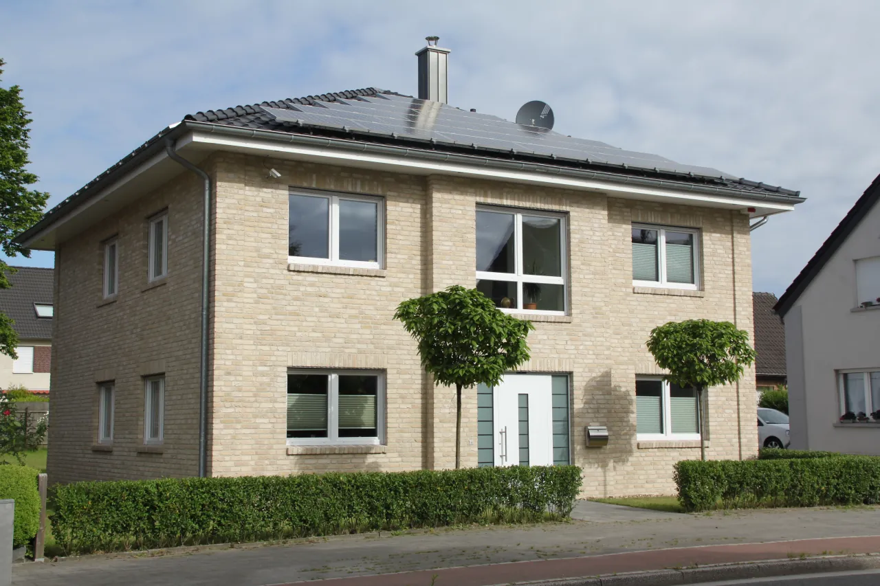 Villa mit weißen Fenstern und gelber Hausfassade